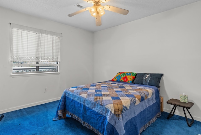 bedroom with a textured ceiling, visible vents, carpet floors, a ceiling fan, and baseboards