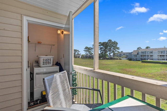 balcony with washing machine and clothes dryer