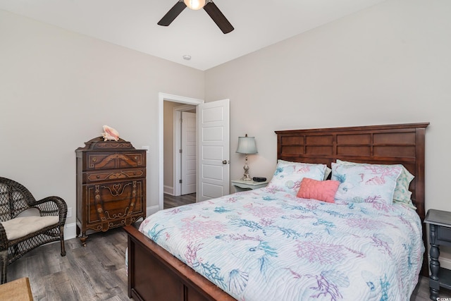bedroom with a ceiling fan, baseboards, and dark wood-style floors