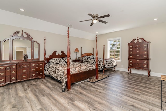 bedroom featuring wood finished floors, baseboards, ceiling fan, recessed lighting, and vaulted ceiling