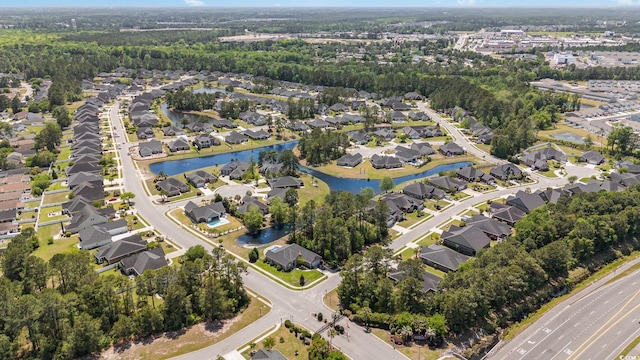 drone / aerial view with a water view and a residential view