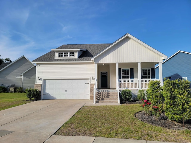 view of front facade featuring a porch, a garage, a front lawn, concrete driveway, and a shingled roof