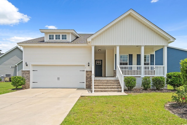 512 Charlton Blvd, Georgetown, SC 29440 - view of front facade featuring covered porch, a front yard, driveway, and roof with shingles