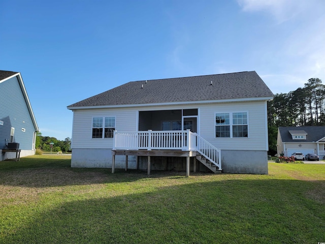 rear view of house with a lawn, a deck, and stairway