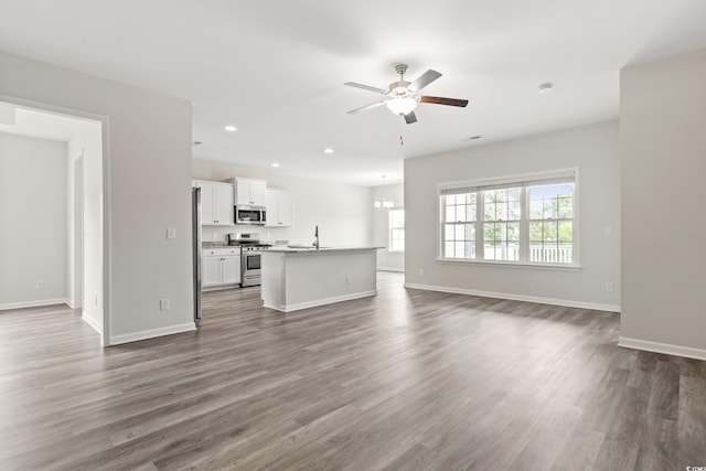 512 Charlton Blvd, Georgetown, SC 29440 - unfurnished living room with ceiling fan, a chandelier, dark wood finished floors, recessed lighting, and baseboards