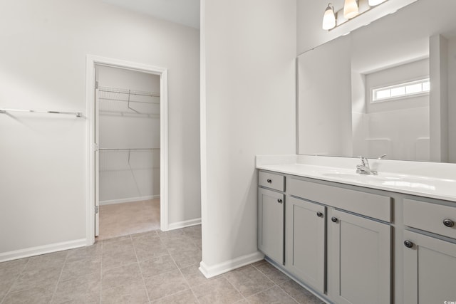 512 Charlton Blvd, Georgetown, SC 29440 - bathroom with vanity, a walk in closet, and baseboards
