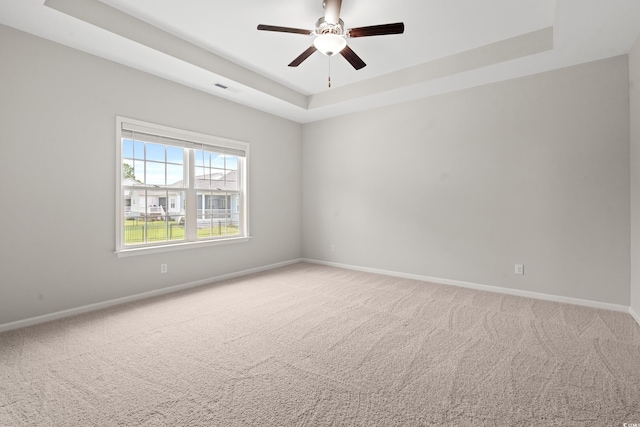 512 Charlton Blvd, Georgetown, SC 29440 - unfurnished room featuring a tray ceiling, baseboards, ceiling fan, and light carpet