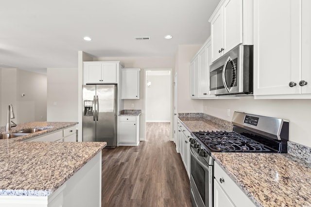 512 Charlton Blvd, Georgetown, SC 29440 - kitchen with stainless steel appliances, a sink, dark wood finished floors, white cabinetry, and light stone countertops