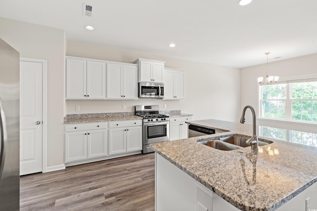 512 Charlton Blvd, Georgetown, SC 29440 - kitchen with appliances with stainless steel finishes, a sink, light wood-type flooring, white cabinets, and recessed lighting