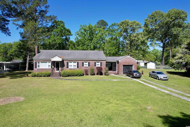 single story home with a garage, a chimney, brick siding, driveway, and a front lawn