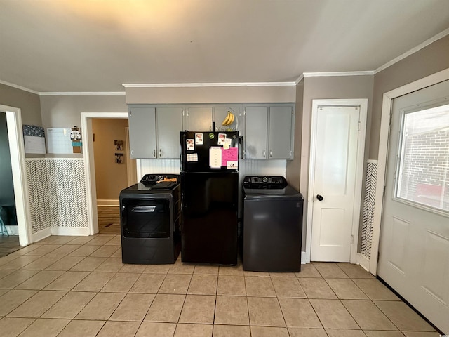 kitchen featuring freestanding refrigerator, gray cabinetry, light tile patterned floors, ornamental molding, and washer and dryer