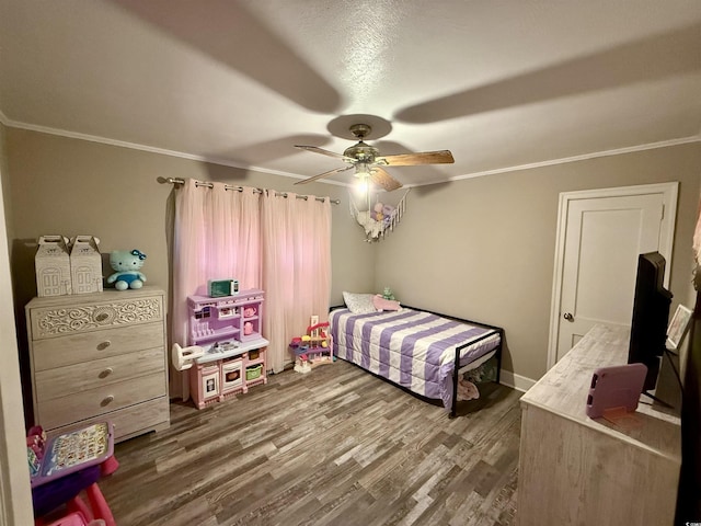 bedroom with ornamental molding, wood finished floors, and a ceiling fan
