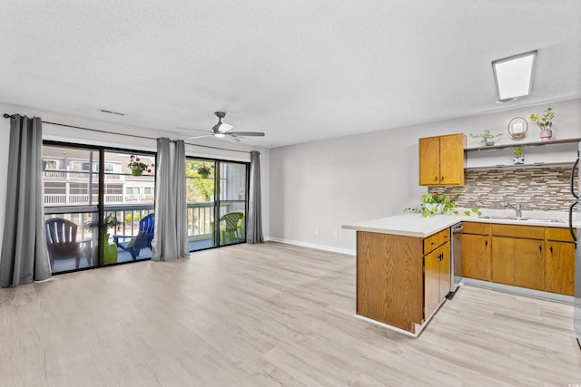 3700 Golf Colony Ln Unit 18-G, Little River, SC 29566 - kitchen featuring a peninsula, light wood finished floors, open shelves, light countertops, and a textured ceiling