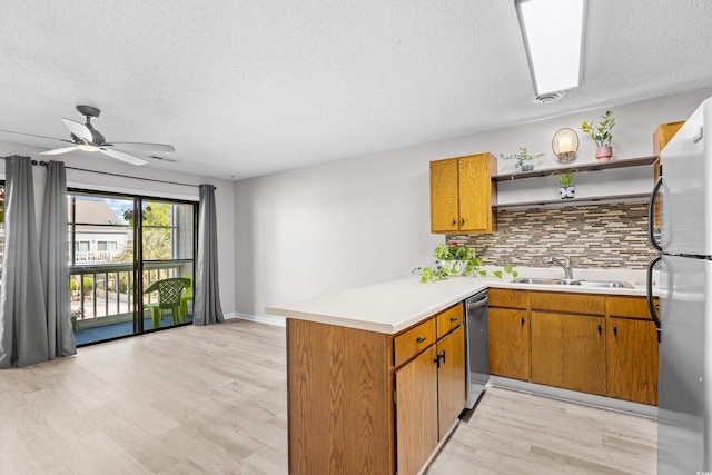 3700 Golf Colony Ln Unit 18-G, Little River, SC 29566 - kitchen with stainless steel appliances, a sink, a peninsula, a textured ceiling, and open shelves