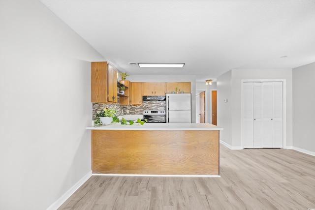 3700 Golf Colony Ln Unit 18-G, Little River, SC 29566 - kitchen featuring freestanding refrigerator, stainless steel electric range, under cabinet range hood, open shelves, and light wood-type flooring