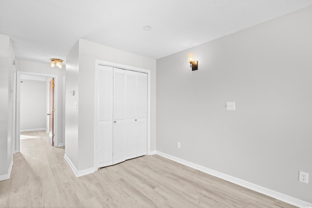 3700 Golf Colony Ln Unit 18-G, Little River, SC 29566 - unfurnished bedroom with light wood-style floors, a closet, and baseboards