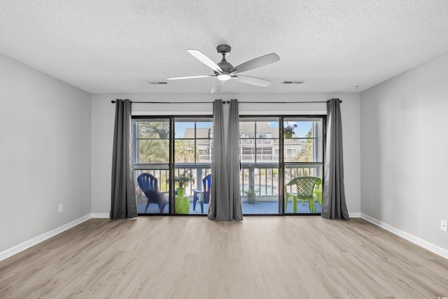 3700 Golf Colony Ln Unit 18-G, Little River, SC 29566 - unfurnished room featuring wood finished floors, a textured ceiling, baseboards, and a ceiling fan