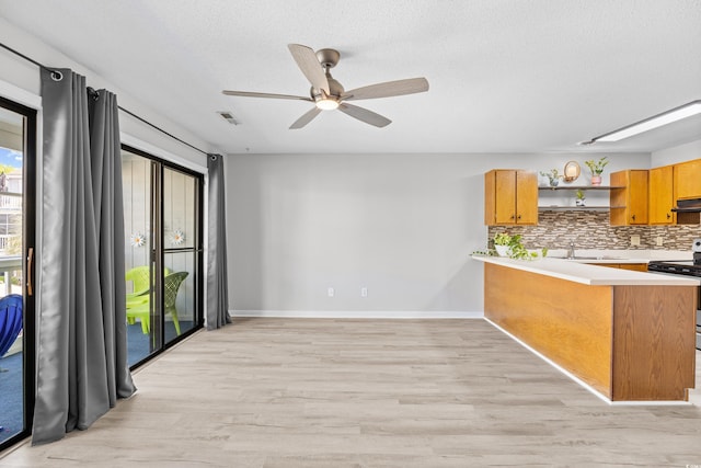 3700 Golf Colony Ln Unit 18-G, Little River, SC 29566 - kitchen with electric range, open shelves, light countertops, light wood-style flooring, and a textured ceiling