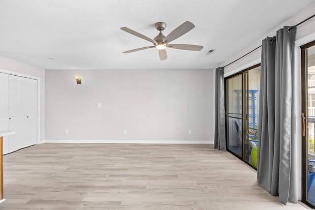 3700 Golf Colony Ln Unit 18-G, Little River, SC 29566 - empty room featuring light wood-style floors, a ceiling fan, a textured ceiling, and baseboards