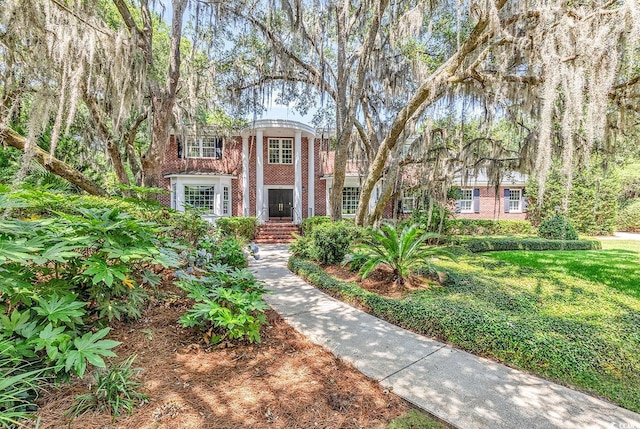neoclassical home with brick siding