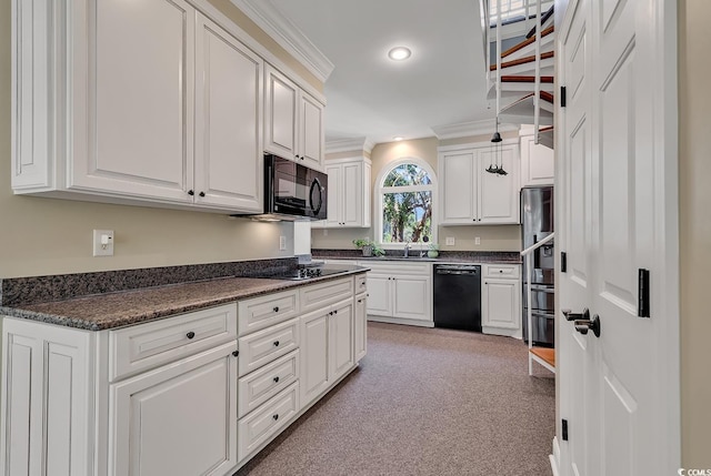 kitchen with black appliances, dark countertops, crown molding, light colored carpet, and white cabinets