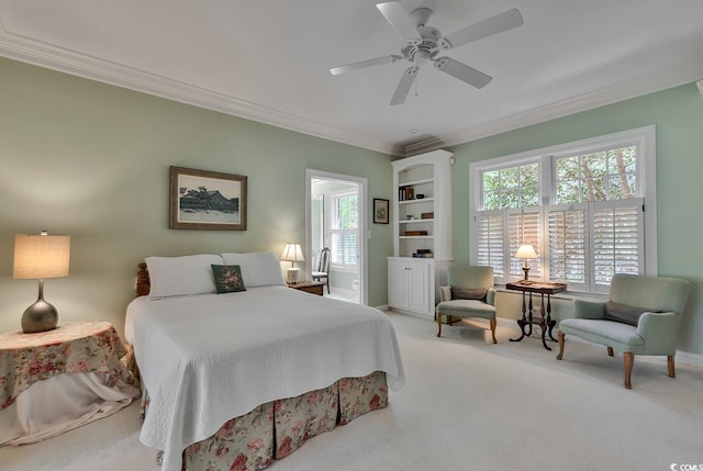 carpeted bedroom with ornamental molding, baseboards, and a ceiling fan