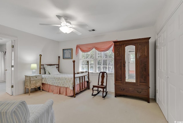 bedroom featuring light carpet, a closet, a ceiling fan, and baseboards