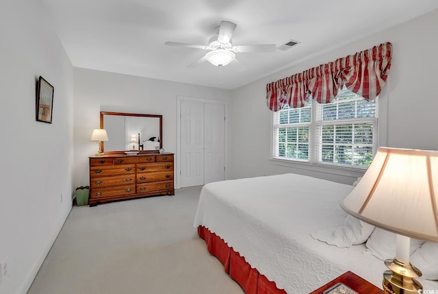 carpeted bedroom with a closet and a ceiling fan