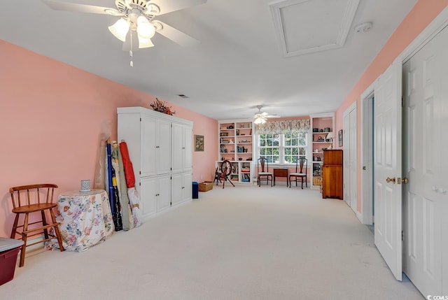 living area with ceiling fan and light carpet