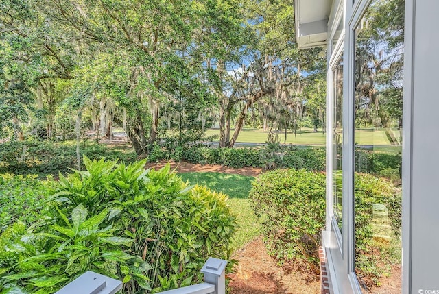 view of yard with view of wooded area