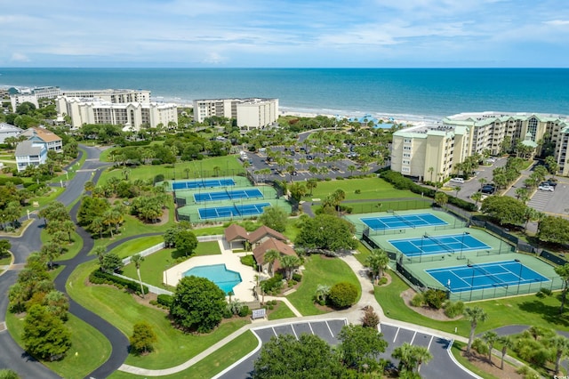 aerial view of a large body of water, a pool area, and apartment complex / building
