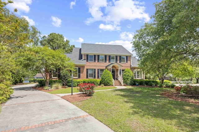8231 Forest Lake Dr, Conway, SC 29526 - colonial home featuring brick siding, driveway, a shingled roof, and a front yard