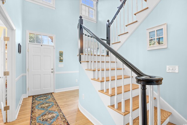 8231 Forest Lake Dr, Conway, SC 29526 - entryway featuring baseboards, a towering ceiling, wood finished floors, and stairs
