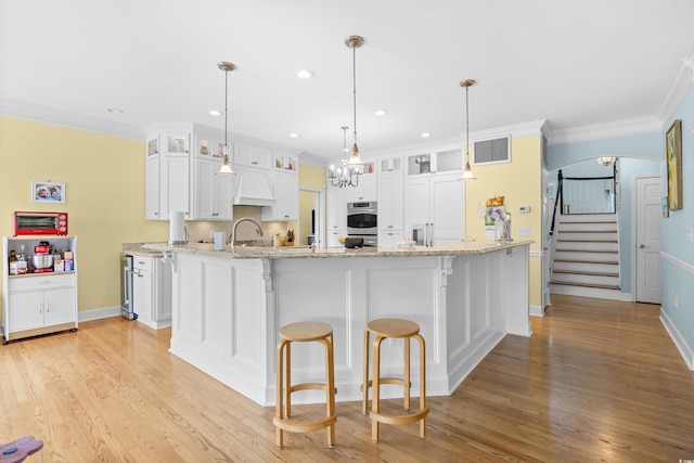 8231 Forest Lake Dr, Conway, SC 29526 - kitchen featuring white cabinets, light wood-type flooring, visible vents, and ornamental molding