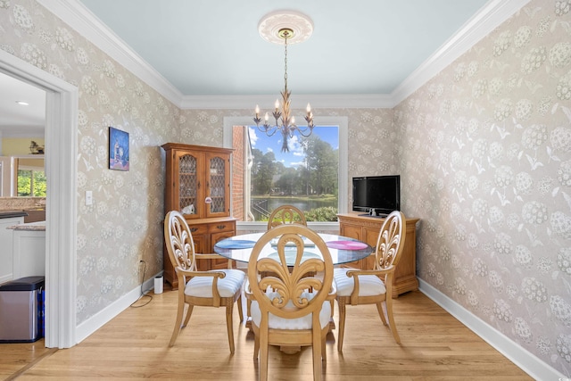 8231 Forest Lake Dr, Conway, SC 29526 - dining space with light wood-type flooring, wallpapered walls, a chandelier, and crown molding