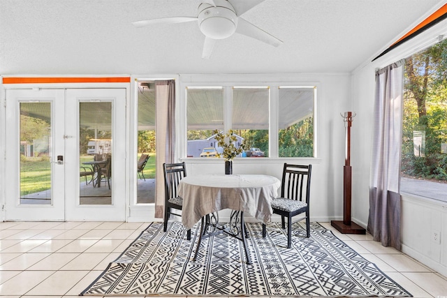 sunroom with french doors, tile patterned flooring, plenty of natural light, and a textured ceiling