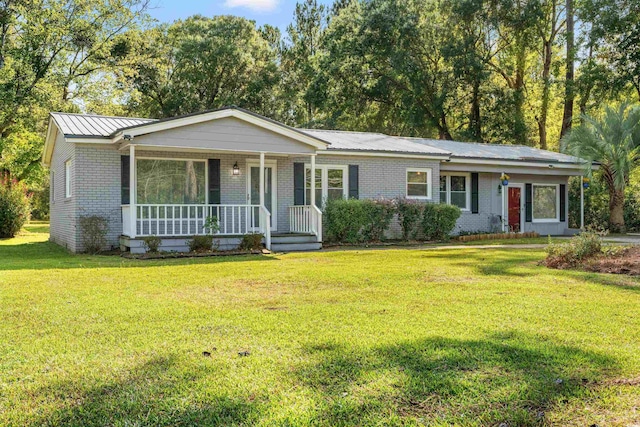 single story home with brick siding, a porch, and a front lawn