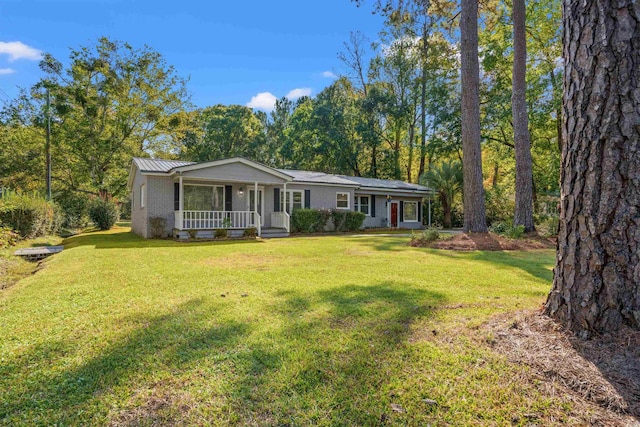 ranch-style home featuring a porch and a front lawn
