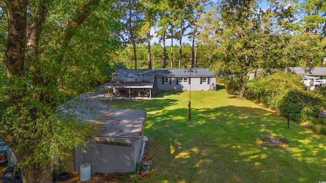 rear view of property featuring a yard