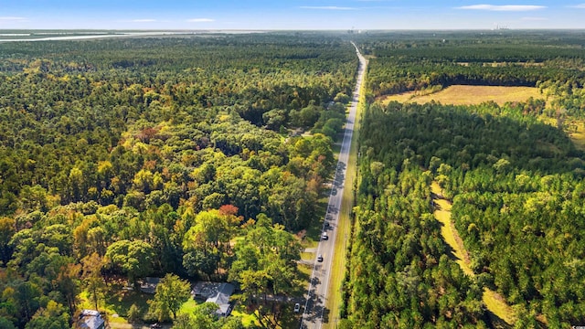 aerial view of property's location featuring a forest