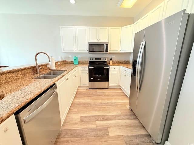1025 World Tour Blvd Unit 205, Myrtle Beach, SC 29579 - kitchen featuring recessed lighting, light stone counters, a sink, light wood-style floors, and appliances with stainless steel finishes