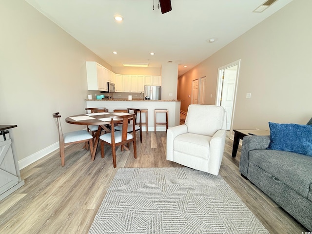 1025 World Tour Blvd Unit 205, Myrtle Beach, SC 29579 - living area with light wood-style floors, visible vents, a ceiling fan, and baseboards