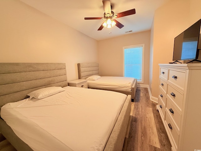 1025 World Tour Blvd Unit 205, Myrtle Beach, SC 29579 - bedroom featuring baseboards, a ceiling fan, wood finished floors, and visible vents