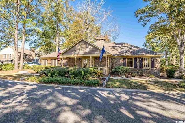 view of front of house featuring covered porch and brick siding