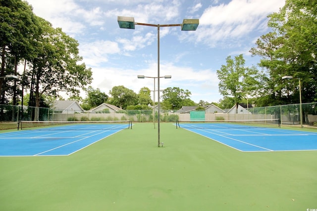 view of sport court featuring fence