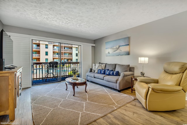 5507 N Ocean Blvd Unit 105, Myrtle Beach, SC 29577 - living area featuring wood finished floors and a textured ceiling