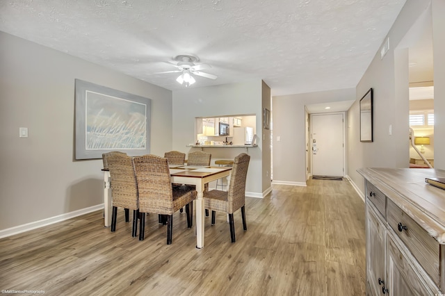 5507 N Ocean Blvd Unit 105, Myrtle Beach, SC 29577 - dining room with light wood finished floors, ceiling fan, and a textured ceiling