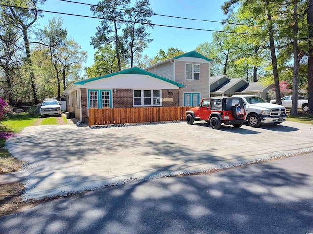 725 Juniper Dr, Surfside Beach, SC 29575 - view of front of property featuring brick siding and fence