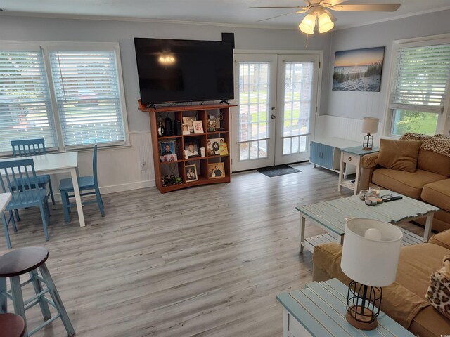 725 Juniper Dr, Surfside Beach, SC 29575 - living room with french doors, a ceiling fan, light wood-style flooring, wainscoting, and ornamental molding
