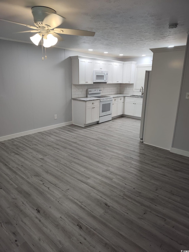 725 Juniper Dr, Surfside Beach, SC 29575 - kitchen with white appliances, baseboards, a sink, decorative backsplash, and a ceiling fan